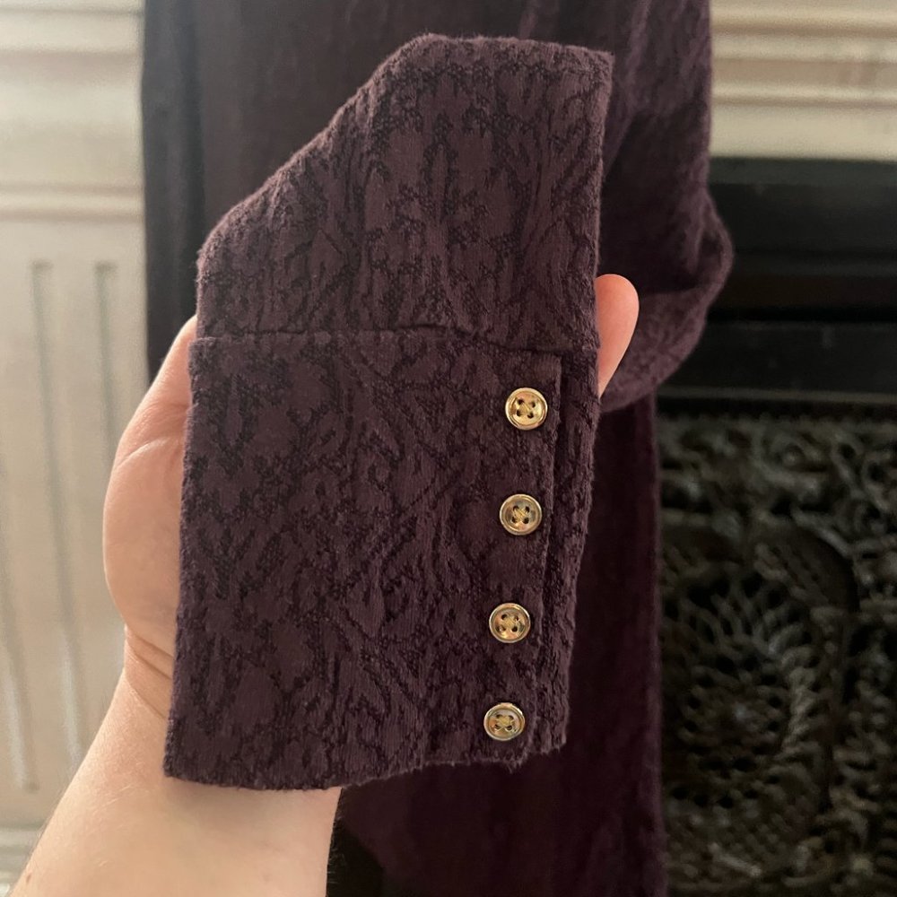 Elegant deep purple long-sleeved shirt with gold accents